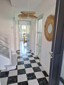 a hallway with a black and white checkered floor at Ô Charme de St Ô 4 étoiles in Saint-Omer +30 photos