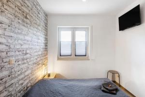 a bedroom with a brick wall and a bed at Ferienwohnung Pfauenhof in Harztor