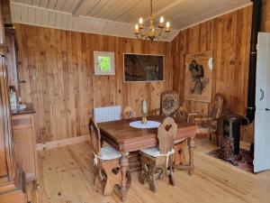 a dining room with a wooden table and chairs at La Germaine in Ribécourt