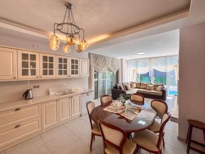a kitchen and living room with a table and chairs at Villa Zeytin in Kusadası