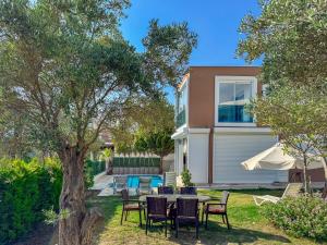 a table and chairs in the yard of a house at Villa Zeytin in Kusadası