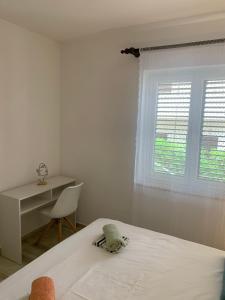 Postel nebo postele na pokoji v ubytování Apartments Vasilić