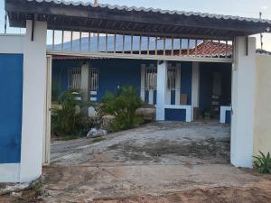a blue and white house with a patio at Casa em Tabatinga praia in Nísia Floresta