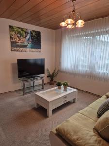 a living room with a couch and a tv at Linnich Apartment für 4 Personen mit Küche in Linnich