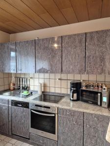 a kitchen with a sink and a stove top oven at Linnich Apartment für 4 Personen mit Küche in Linnich
