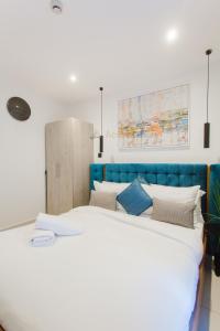 a bedroom with a large bed with a blue headboard at Accra Luxury Apartments at Loxwood in Accra +108 photos