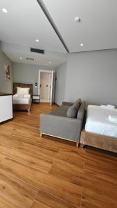 a living room with two beds and a couch at King Hotel Ksamil in Ksamil