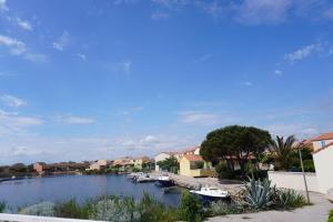 a view of a river with boats in a town at Barcarelles avec PISCINE Plage clim 5 personnes in Le Barcarès
