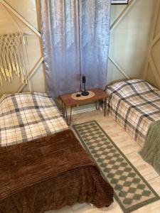 a room with two twin beds and a table at Adella's Blue Mountain Coffee Farmstay in Kingston