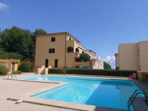 a large swimming pool in front of a building at YourHouse Sol i Mar 2 beach apartment in Cala Mesquida