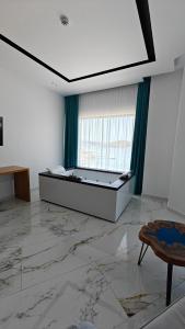 a large room with a bed and a window at King Hotel Ksamil in Ksamil
