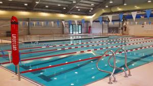 a large swimming pool with blue water at High-View Catskills Cabin in Margaretville