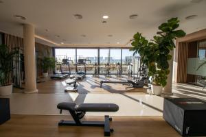 a gym with cardio equipment in a building at ELEGANT APARTMENT in MARBELLA, Sea views, Infinity & Pool, Sauna, Gym, SPA, 5 min to the Beach in Marbella