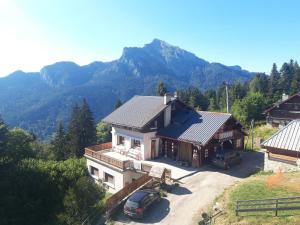 an aerial view of a house with mountains in the background at Le Grand Som - Proche Station de ski in Saint-Pierre-de-Chartreuse
