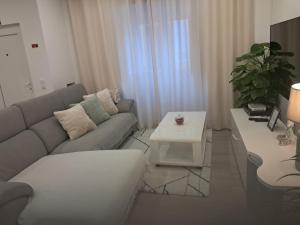 a living room with a couch and a table at My home in Cercal