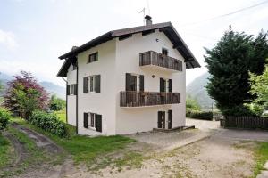 una casa blanca con techo negro en Agritur Montibeller Fravort, en Marter di Roncegno