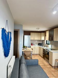a living room with a couch and a kitchen at Veranda Blue in Nikiana