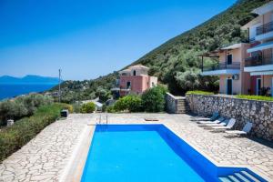 a villa with a swimming pool next to a building at Veranda Blue in Nikiana