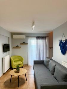 a living room with a couch and a green chair at Veranda Blue in Nikiana