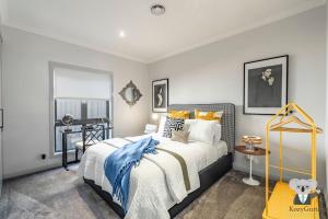 Un dormitorio con una cama con una manta azul y blanca. en Casa Del Vogue | Luxury | Lithgow Blue Mountain, en Lithgow