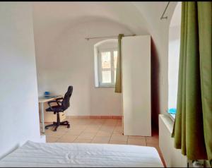 a bedroom with a bed and a desk and a chair at City Rooms Steyr in Steyr +10 photos