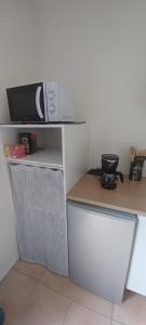 a kitchen with a microwave on top of a counter at Les lavandières in La Pommeraie-sur-Sèvre +24 photos