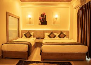 Letto o letti in una camera di Premier Hideaway Hotel Bhedetar
