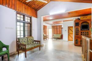 a living room with a couch and a tv at Exotic Villa Homestay in Guwahati
