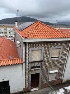 a building with an orange tile roof at Cici Guesthouse in Caminha