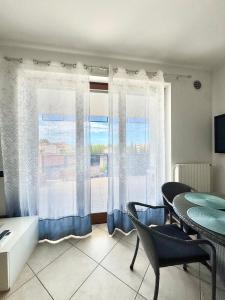 a living room with a table and a window at HomeAway Pescara Airport in San Giovanni Teatino +4 photos