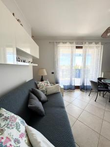 a living room with a couch and a dining room at HomeAway Pescara Airport in San Giovanni Teatino