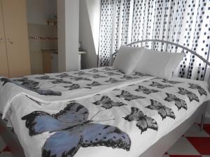 ein Bett mit einer schwarzen und weißen Bettdecke in der Unterkunft Villa Angel Apartments - OHRID- in Ohrid