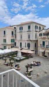 a group of people sitting in front of a building at MARCELLA Appartamento Full-optional in Centro Storico in Tropea