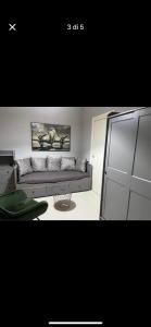 a living room with a couch and a table at Luxro Home Crotone in Crotone +1 photo