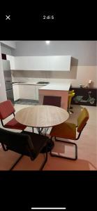 a kitchen with a table and chairs in a room at Luxro Home Crotone in Crotone