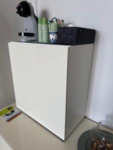 a white refrigerator with a basket on top of it at HomeAway Pescara Airport in San Giovanni Teatino