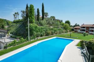 an image of a swimming pool in a villa at La Pietra del Garda by Bookinggardalake in Montinelle