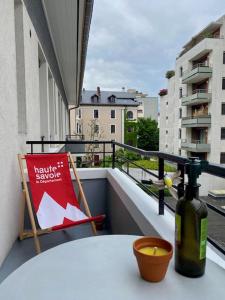 a bottle of wine sitting on a table on a balcony at Alery Loft in Annecy