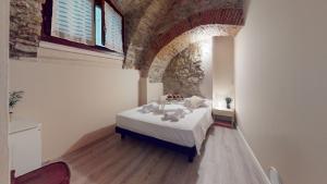 a bedroom with a bed in a room with a stone wall at La Pietra del Garda by Bookinggardalake in Montinelle +29 photos