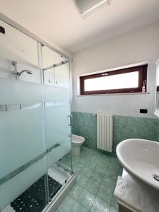 a bathroom with a glass shower and a sink at HomeAway Pescara Airport in San Giovanni Teatino