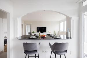 a kitchen with a table and chairs in a room at Tranquil Hideaway on Gellért Hill with Parking in Budapest