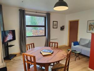 a living room with a table and a couch at Ailleurs La Chalp à Saint-Véran in Saint-Véran