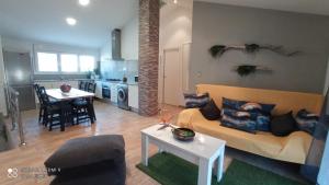 a living room with a couch and a table at Apartamento 2 habitaciones ZEN in Deltebre +17 photos