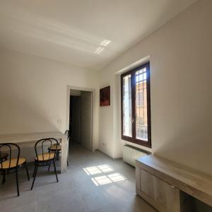 a room with two chairs and a table and a window at La Casetta del 26 B&B in Corsico +27 photos