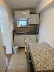 a small kitchen with a table and a counter top at Apartmani Niko in Neum +17 photos