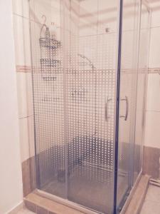 a shower with a glass door in a bathroom at Art & Books Guesthouse Alexandroupoli in Alexandroupoli