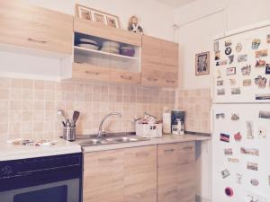 a kitchen with a sink and a refrigerator at Art & Books Guesthouse Alexandroupoli in Alexandroupoli