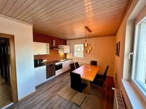 a kitchen with a table and chairs in a room at Appartements Skruba in Steindorf am Ossiacher See