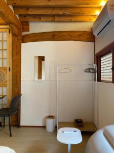 a living room with a refrigerator and a table at Stay 148 in Seoul