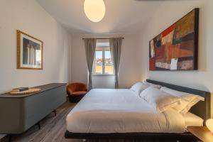 a bedroom with a bed and a desk and a window at The Tower Glimpse in Florence
